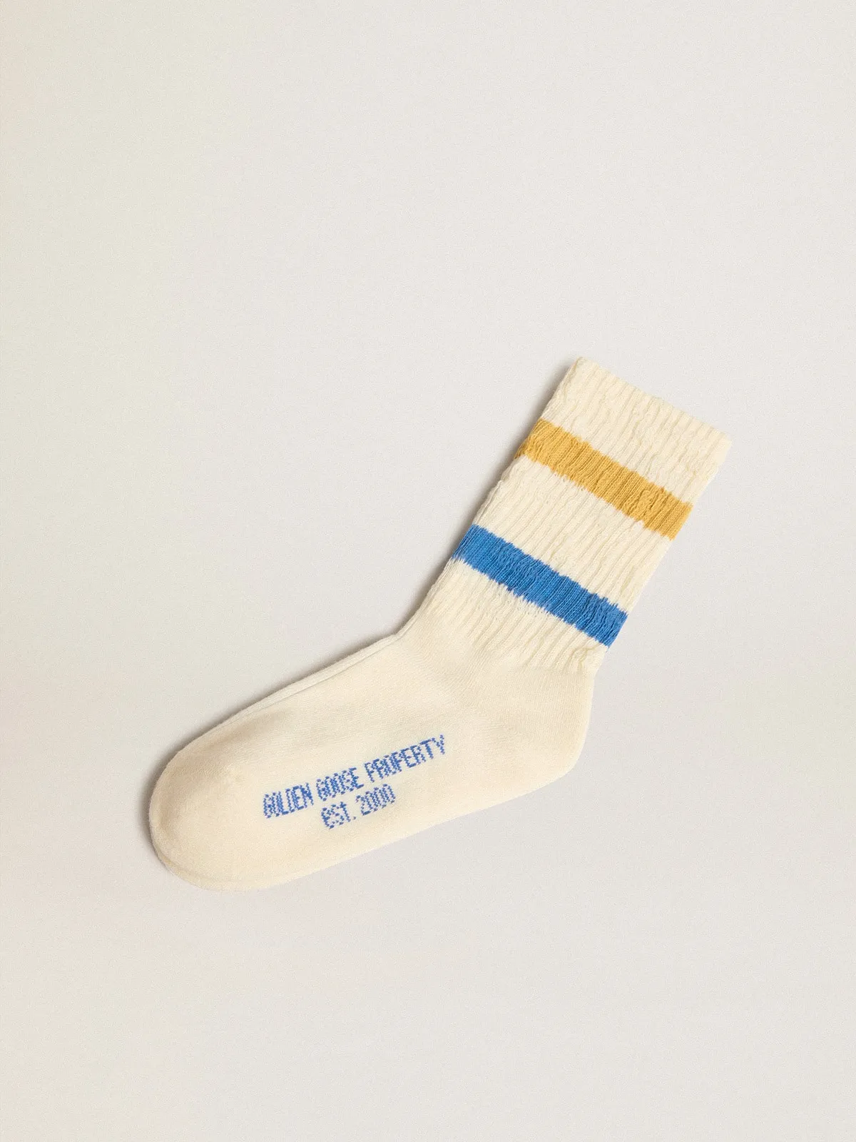 Worn white Kids socks with distressed details and two-tone bright blue and mustard stripes