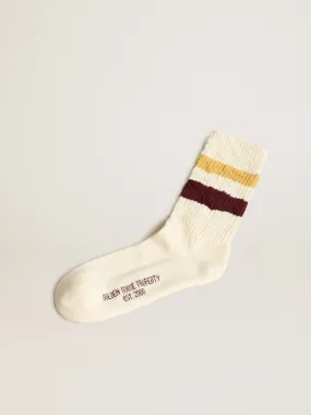 Worn white with distressed details and two-tone mustard and burgundy stripes