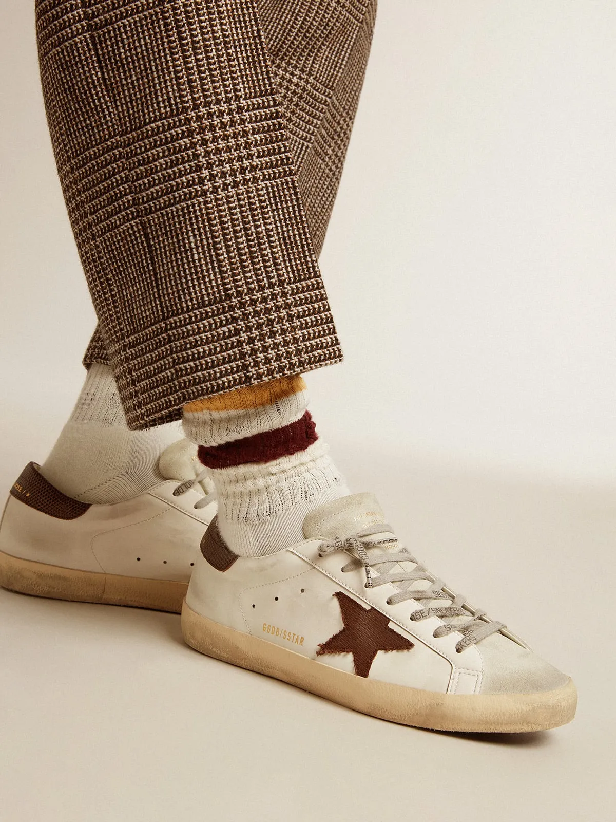 Worn white with distressed details and two-tone mustard and burgundy stripes